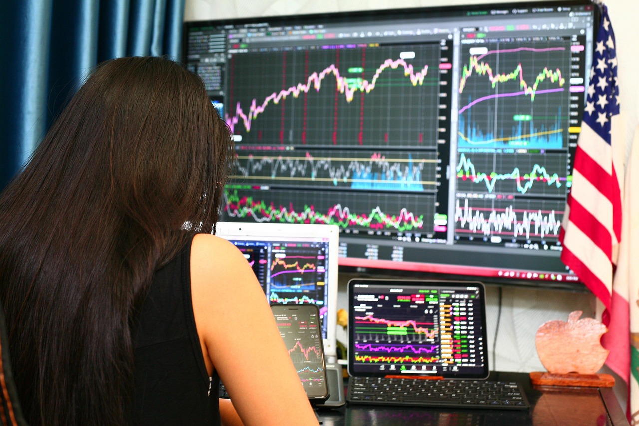 Trader at a computer with analytical screens — modern sharps run quantitative operations indistinguishable from hedge fund desks